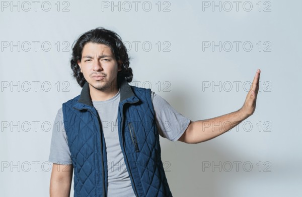 Displeased young man rejecting with palms hands isolated. Upset person making rejection gesture isolated, He frowns in disgust