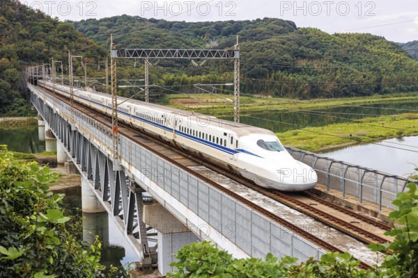 Shinkansen type N700 high-speed train of Japan Rail JR train on the Sanyo Shinkansen line in Kurashiki, Japan, Asia