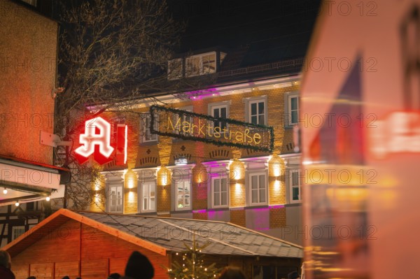 An illuminated pharmacy and the market street at night, Lichternacht Fest, Nagold, Black Forest, Germany, Europe