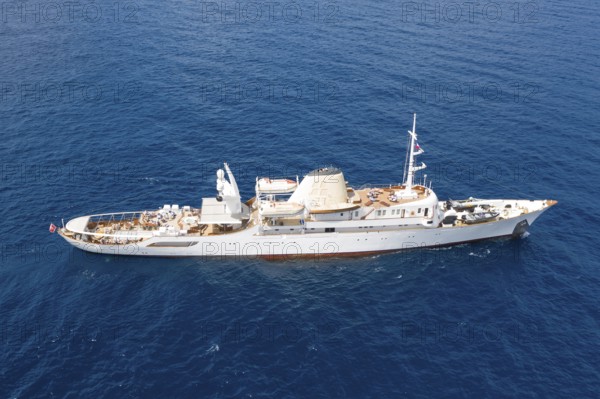 Aerial view 99 metre long motor yacht Christina O, former frigate built in 1942 by Canadian Vickers, converted for Aristotle Onassis, on board were Maria Callas, Winston Churchill, John F. and Jackie Kennedy, Tito, Grace Kelly, Prince Rainier III of Monaco, Frank Sinatra, Richard Burton, Elizabeth Taylor, Greta Garbo, John Wayne, Marilyn Monroe, John D. Rockefeller, Paul McCartney, Prince Andrew, Sarah Ferguson, Madonna, Johnny Depp. Here the yacht is cruising off Menton on the French Riviera, Mediterranean Sea