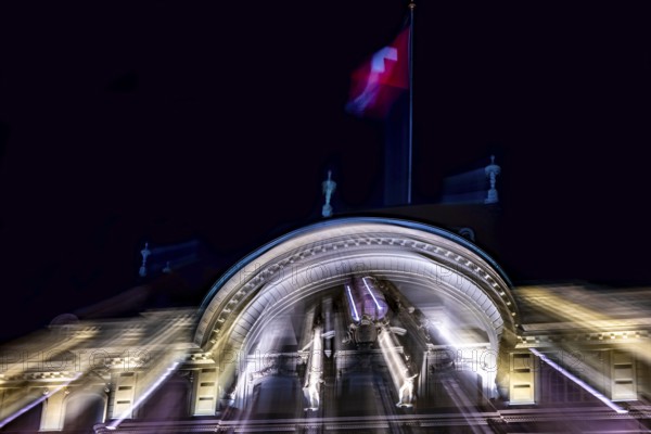Beautiful Illuminated Swiss National Bank and Swiss Flag at Night in City of Bern, Bern Canton, Switzerland, Europe