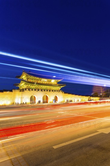 Colorful streaks of light from car lights on moving traffic in front of historic Gyeongbokgung Palace, Gwanghwamun entrance gate at dusk in downtown Seoul, South Korea, Asia