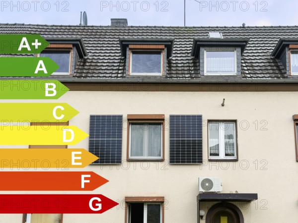 Energy efficiency classes, two solar panels on the façade of an apartment block in Hilden, Germany, Europe