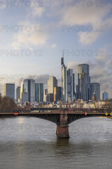 A big city in the evening at sunset. Modern buildings in a skyline by the river. Skyscrapers are reflected in the water. Modern architecture of the metropolis Frankfurt am Main, Germany, Europe