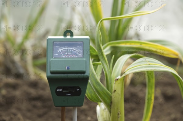 The meter has various indications illustrating its role in monitoring and measuring the moisture levels in the soil, a critical factor for successful crop cultivation