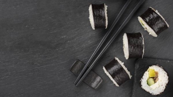 Sushi rolls with chopsticks copy space