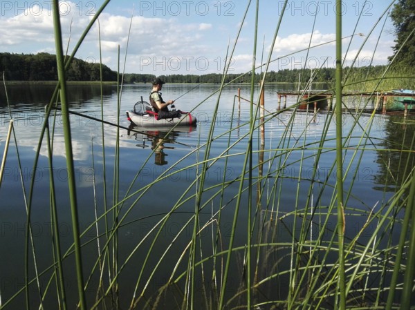 Angler with belly boat on Lake Lübbe