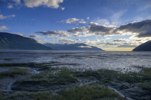 Vast coastal landscape at sunset with calm water under a cloudy sky, Turnagain Arm, Alaska, USA, North America