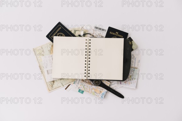 Overhead view blank spiral notebook passport map isolated white background