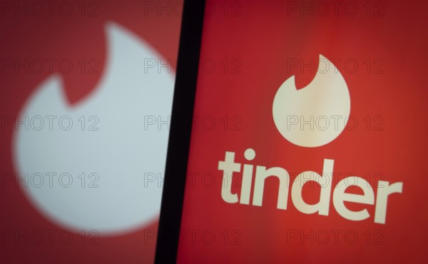 tinder logo is seen on a smartphone