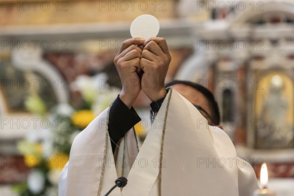 The elevation of the Sacramental Bread during the catholic liturgy