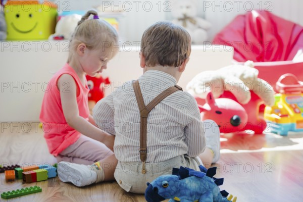 Children sitting floor playroom