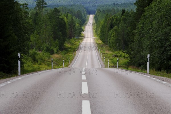 Lonely country road through forest, Värmland, Sweden, Europe