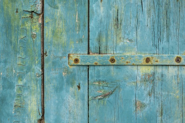 Old wooden door with peeling paint and iron fittings, texture, background, Montenegro, Balkans, Europe