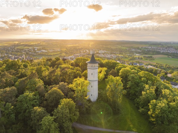 A tower rises in the sunset above the green forest and the vast countryside, Engelberg Tower, Leonberg, Germany, Europe