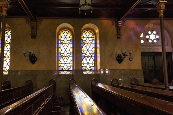 Incidence of light through stained glass windows, star, reflections, wooden benches, Great Synagogue, Nagy Zsinagoga, Pest district, Budapest, Hungary, Europe