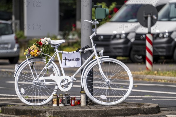 A ghost bike at the scene of an accident where a cyclist was run over by a lorry two days earlier and died, the white-painted bike is intended to serve as a memorial at the junction to commemorate the accident and remind people to drive more carefully, Essen-Kray, North Rhine-Westphalia, Germany, Europe