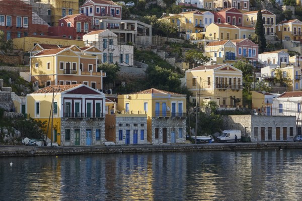 Colourful houses on the shore with water view, Symi Town, Symi, Dodecanese, Greek Islands, Greece, Europe