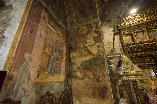 Richly decorated altar table and frescoes in a church showing detailed religious scenes, Thari Monastery, Moni Thari, near Gadouras Reservoir, remote mountain region, Rhodes, Dodecanese, Greek Islands, Greece, Europe