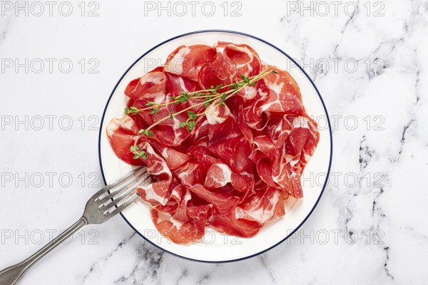 Plate with sliced cured meat, pork neck, prosciutto coppa, Italian delicacy