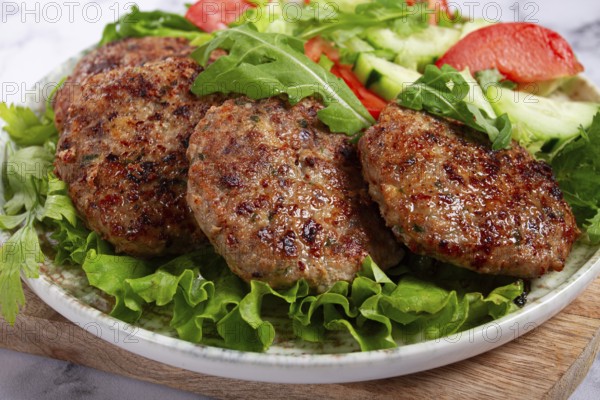 Fried cutlets, mixed minced meat, with vegetable salad, homemade, top view, no people