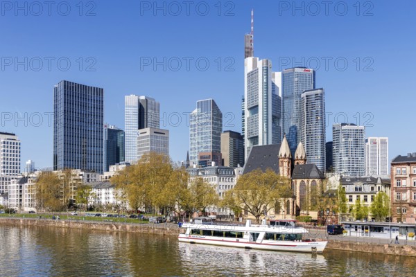 Frankfurt skyline skyscrapers with banks on the river Main with excursion boat in Frankfurt, Germany, Europe