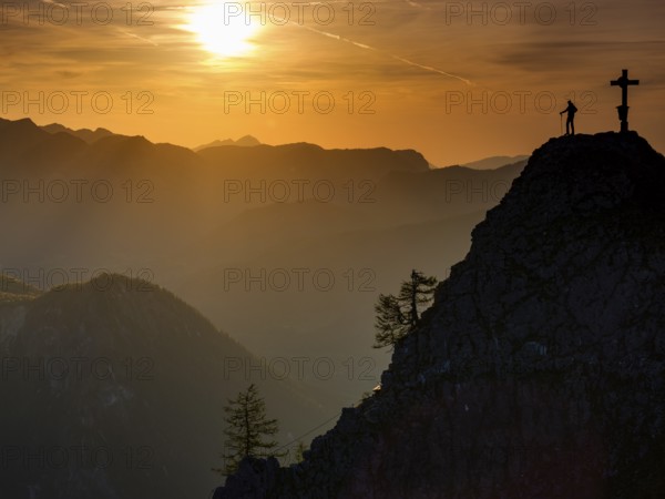 Mountaineers at the summit cross of the Kleiner Jenner at sunset, Reiteralpe in the background, Berchtesgaden National Park, Schönau am Königssee, Upper Bavaria, Bavaria, Germany, Europe