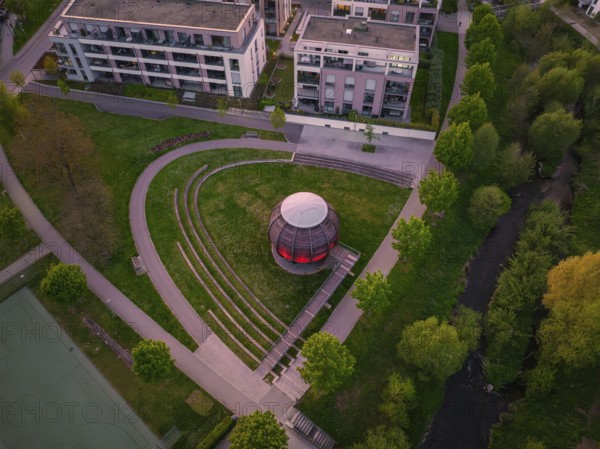 Aerial view of a modern wooden construction in the park with trees and surrounding buildings at dusk, Forstkugel, Nagold Black Forest, Germany, Europe
