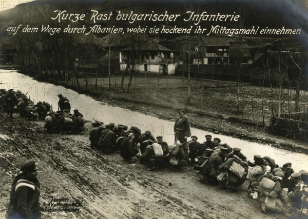 Short rest of Bulgarian infantry on their way through Albania, having their lunch while crouching, 1914 - 1918, World War I, reproduction of a war postcard