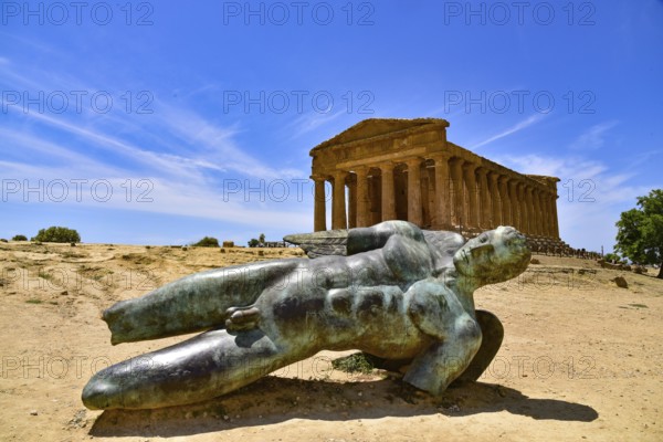 Statue of the fallen Icarus in front of the Temple of Concordia in the Valley of the Temples near Agrigento in Sicily, Italy, Europe