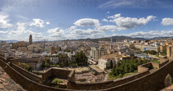 Panoramic view over the historic city of Malaga in Spain, under a clear blue sky with picturesque clouds, Malga, Spain, Europe