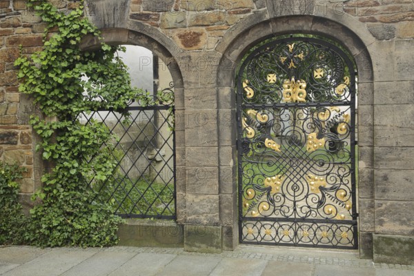 Metal door with golden decorations to the cemetery, churchyard, metal grille, two, wrought iron work, arts and crafts, inner courtyard, St. Mary's Cathedral, Freiberg, Saxony, Germany, Europe