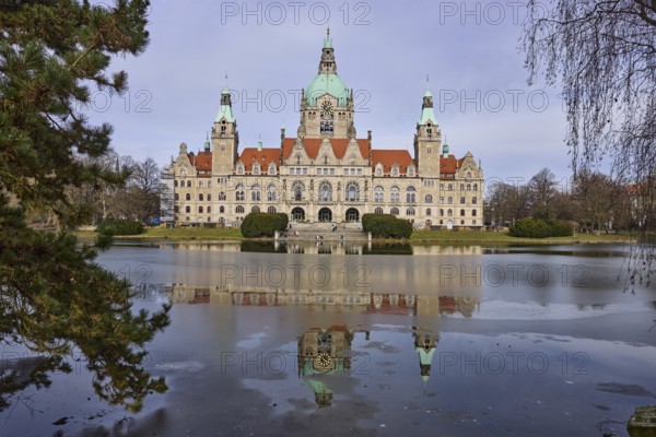 New Town Hall Hanover, architect Hermann Eggert, architectural style Neo-Renaissance, Wilhelminism, ice surface, abstract reflections, pond, mesh pond, park, Maschpark, pines (Pinus), lawn, tree, diffuse light, milky blue cloudy sky, slightly sunny, Hanover, state capital, Hanover region, Lower Saxony, Germany, Europe