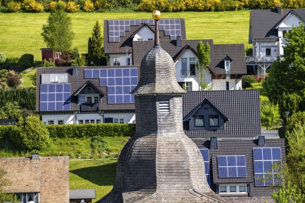 The village of Oberkirchen, district of Schmallenberg, in the Hochsauerland district, St. Gertrudis Church, many residential buildings with photovoltaic modules on the roofs, North Rhine-Westphalia, Germany, Europe