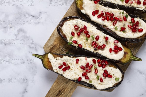 Fried eggplant with sauce, decorated with microgreens and pomegranate seeds, eggplant appetizer, top view, homemade, no people