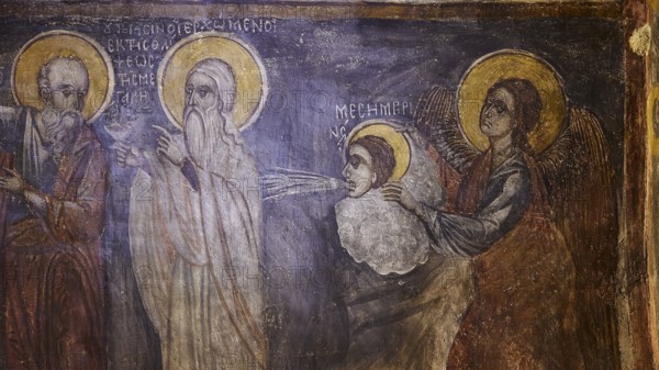 A fresco with holy figures and angels in spiritual interaction, surrounded by ancient lettering, Easter 2025, Church of the Dormition of the All-Holy God Bear, Kimisis tis Theotokou, Asklipio, Rhodes, Dodecanese, Greek Islands, Greece, Europe