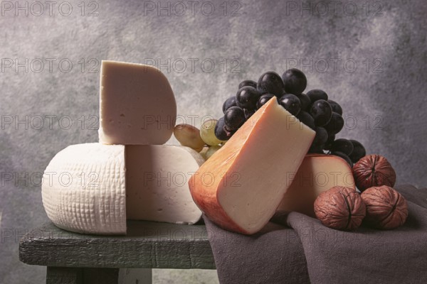 Georgian cheese, Imeretian and smoked suluguni, grapes, nuts, on a cutting board, Georgian cuisine, no people