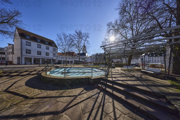 Stem plant, fountain, park, stainless steel railing, natural stone staircase, residential and commercial building, bare trees, backlight of the sun, shadow, blue sky, cloudless, Eisenbahnstraße, Saarbrücken, state capital, regional association Saarbrücken, Saarland, Germany, Europe