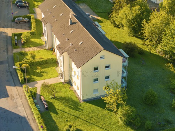 Apartment house surrounded by green lawns and trees on a sunny day, Calw, Black Forest, Germany, Europe