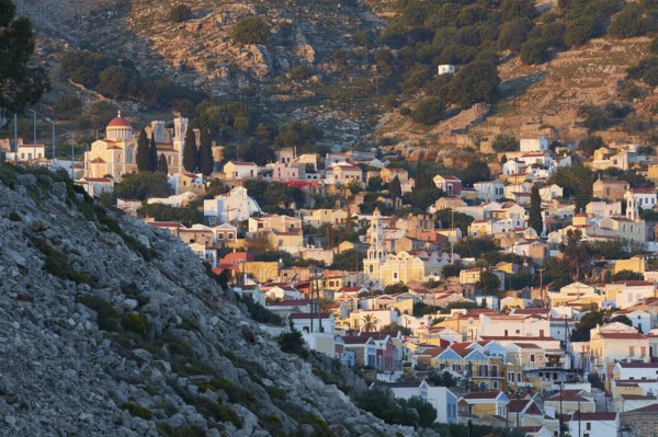 A picturesque hilltop village with traditional stone houses and a summery atmosphere, Symi Town, Symi, Dodecanese, Greek Islands, Greece, Europe