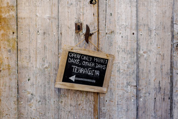 Wooden door with small slate plaque in the old town of Santanyi, Majorca, Balearic Islands, Spain, Europe