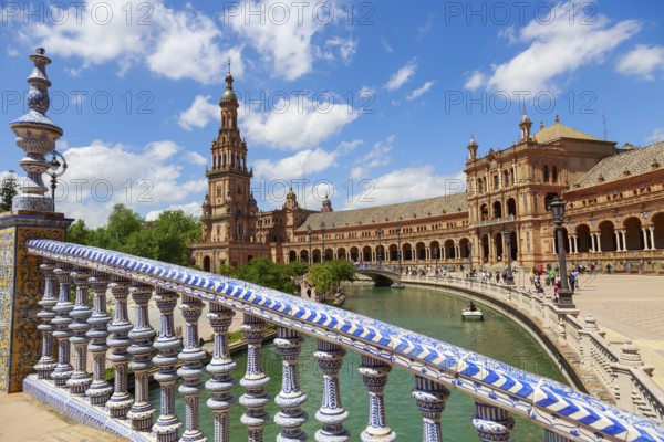 Plaza de España in Seville with magnificent architecture and bridge on a sunny day with clouds, Seville, Spain, Europe
