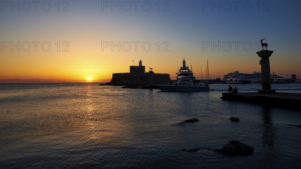 Harbour with boats and fortress, sunrise, dawn, Fort of Saint Nikolaos, Mandraki Harbour, Rhodes Town, Rhodes, Dodecanese, Greek Islands, Greece, Europe
