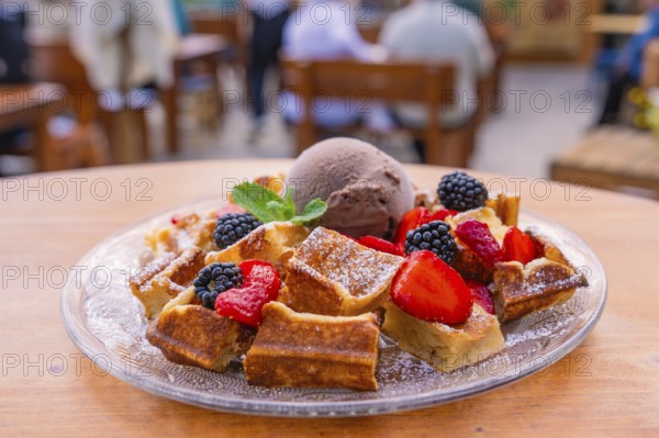 Appetising presentation of waffles with berries and ice cream on the terrace, Cafehäusle Calw, Black Forest, Germany, Europe