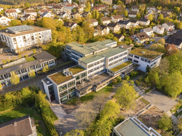 Urban area with modern architecture, surrounded by autumnal landscape from a bird's eye view, Christiane Herzog Realschule, Nagold, district of Calw, Germany, Europe
