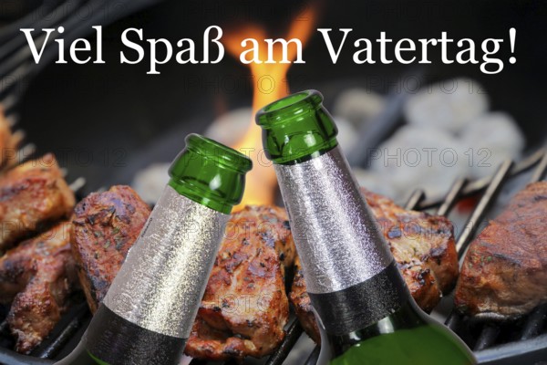 (Photomontage) Father's Day symbol: Two beer bottles in front of barbecued meat and text VIEL SPASS AM VATERTAG