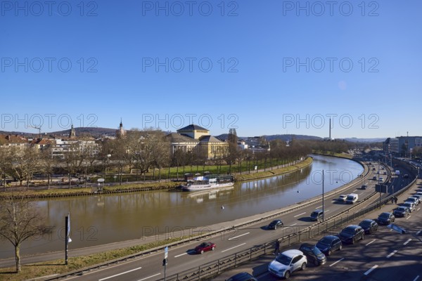 Long shot, Saarland State Theatre, general architecture, Saar river, streets, cars, trees, parking lane with vehicles, river bank, footpath and cycle path, reflections on the water surface, bird's eye view, blue sky, cloudless, Franz-Josef-Röder-Straße, A620 motorway, Saarbrücken, state capital, Saarbrücken regional association, Saarland, Germany, Europe