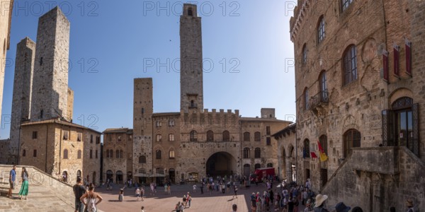 SAN GIMIGNANO, ITALY, SEPTEMBER 20, 2023, Main square Piazza del Duomo in San Gimignano with its famous palace towers, Rognosa tower and Theater dei Leggieri in the center, Italy, Europe