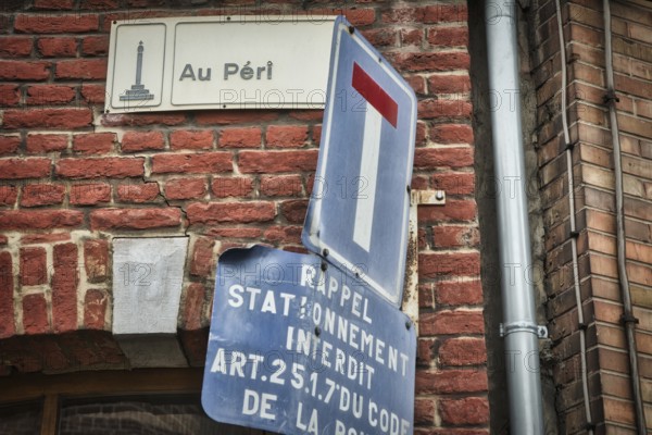 Liege, Belgium, June 2021: Street sign of Au Peri in Liege on a brick wall. Close-up and detail, Europe