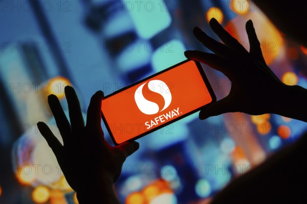 In this photo illustration, the Safeway logo seen displayed on a smartphone